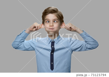 Caucasian boy making monkey face. Caucasian boy making monkey face. 73123794