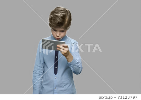 Handsome caucasian boy using smartphone. Handsome caucasian boy using smartphone. 73123797