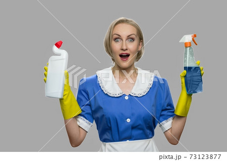 Excited housekeeping woman presenting cleaning supplies. Excited housekeeping woman presenting cleaning supplies. 73123877