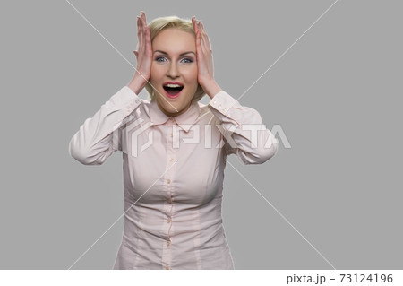 Happy stunned woman looking at camera. 73124196
