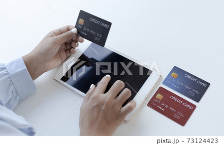 Women use Tablet to register online purchases using credit card payments, Convenience in the world of technology and the internet, Shopping online and banking online concept. Women use Tablet to register online purchases using credit card payments, Convenience in the world of technology and the internet, Shopping online and banking online concept. 73124423