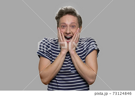 Portrait of emotional teen boy on gray background. Portrait of emotional teen boy on gray background. 73124846