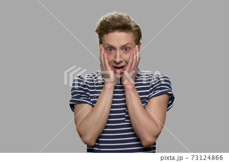 Close up shocked face of teenage boy. 73124866