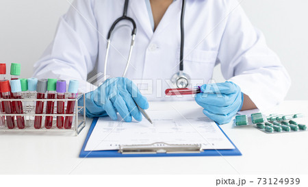 Scientists or physicians analyze the blood sample in vitro to prepare a vaccine against a new strain of viruses, Examination with blood test tubes, Vaccine Research and Science concept. Scientists or physicians analyze the blood sample in vitro to prepare a vaccine against a new strain of viruses, Examination with blood test tubes, Vaccine Research and Science concept. 73124939