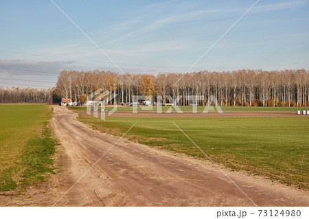 Agircutural field with dirt road Agircutural field with dirt road 73124980