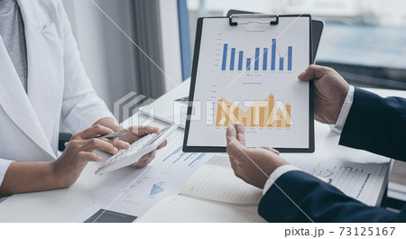 President and the marketing staff of the company convened the earnings revenue and analysis of real estate data graph in the office, Brainstorming ideas about finance and accounting concept. 73125167