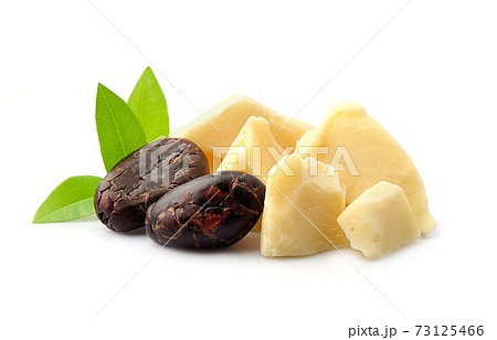 Cacao beans with butter piece on white backgrounds. Cacao beans with butter piece on white backgrounds. 73125466