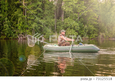 Fisherman in a boat 73125518