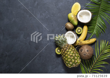 Mix Tropical fruit on dark background, top view. Healthy eating , Nutrition and diet concept Mix Tropical fruit on dark background, top view. Healthy eating , Nutrition and diet concept 73125639