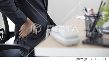 Asian man employee is resting after her hard work and overtime late at the office, relaxing the body fatigue, Wrist pain. Asian man employee is resting after her hard work and overtime late at the office, relaxing the body fatigue, Wrist pain. 73125971