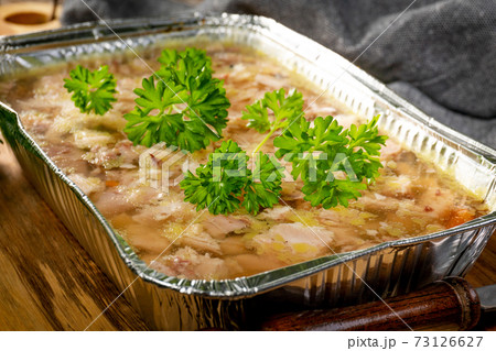 Jelly with shredded chicken meat in a mold. Jelly with shredded chicken meat in a mold. 73126627