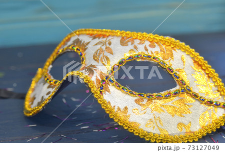 Mardi gras mask and beads on a wooden background. Madi Gras carnival accessories, confetti, Festive, venetian or carnivale mask. Masquerade celebration concept 73127049