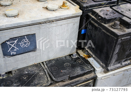 A pallet with used car batteries awaiting recycling 73127793