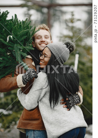 Mixed couple choosing a christmas tree 73129207