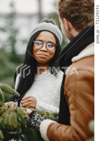 Mixed couple choosing a christmas tree 73129241
