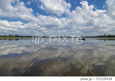 Local fisherman, lake and Neak Pean temple, Angkor, Cambodia. Local fisherman, lake and Neak Pean temple, Angkor, Cambodia. 73129439