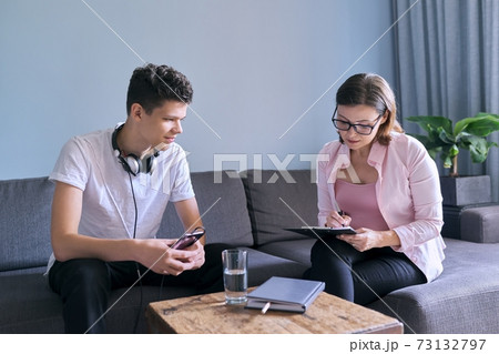 Teenage boy at meeting with female professional doctor psychologist Teenage boy at meeting with female professional doctor psychologist 73132797
