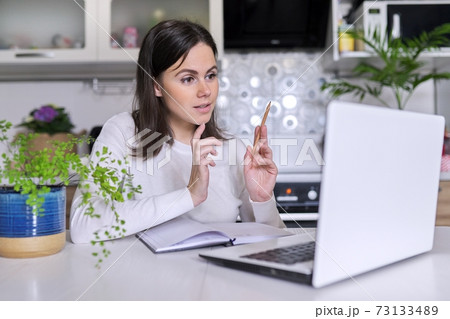 Young female working in home office using laptop, business woman, teacher 73133489