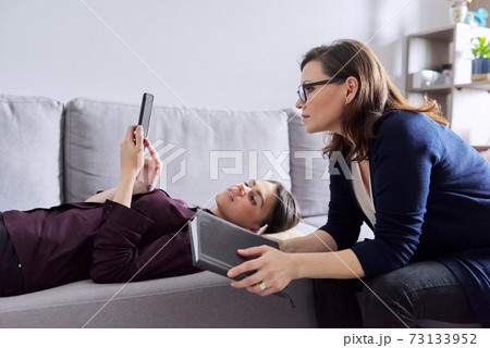 Young woman at consultation with psychologist. Female patient lying on couch 73133952