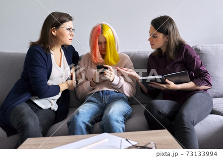 Mother and daughter teenager at consultation with psychologist, problems of adolescence Mother and daughter teenager at consultation with psychologist, problems of adolescence 73133994