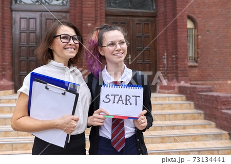 Start school, female teacher and girl student together 73134441