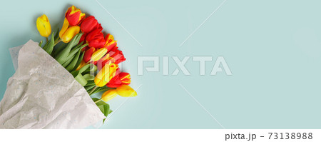 Bouquet Red Yellow tulips flowers on blue background. Waiting for spring, seasonal holiday. Happy Easter card, 8 march Woman International Day. Flat lay, top view, copy space, banner, flyer 73138988
