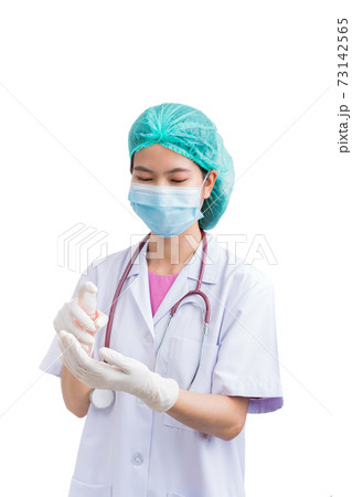 Medical physician doctor or nurse uniform wearing surgical mask holding bottle of sanitizing spray or gel 73142565