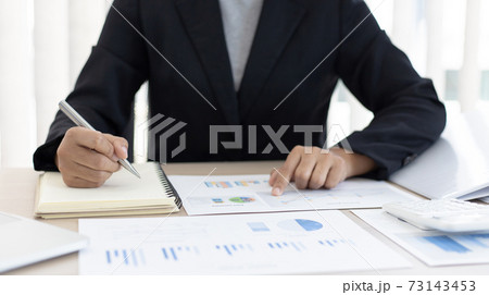 Accounting businesswomen are calculating income-expenditure and analyzing real estate investment data, Dedicated to the progress and growth of the company, Financial and tax systems concept. 73143453