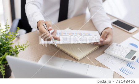 Financial businessmen analyze the graph of the company's performance to create profits and growth, Market research reports and income statistics, Financial and Accounting concept. 73143458