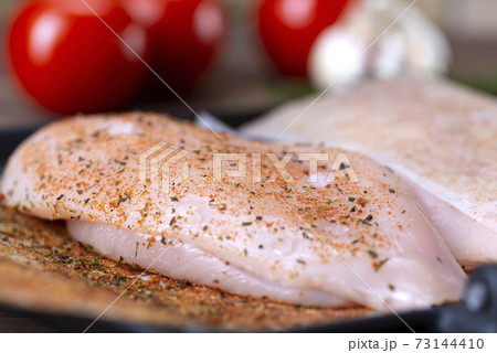 raw chicken breast with spices prepared for roasting 73144410