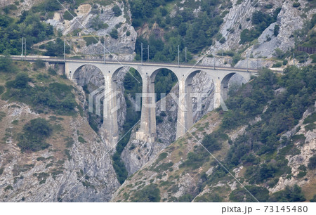 Old stone viaduct in the Swiss mountains 73145480
