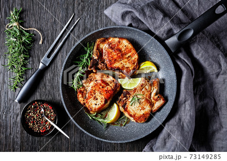 fried pork chops on a skillet, top view 73149285