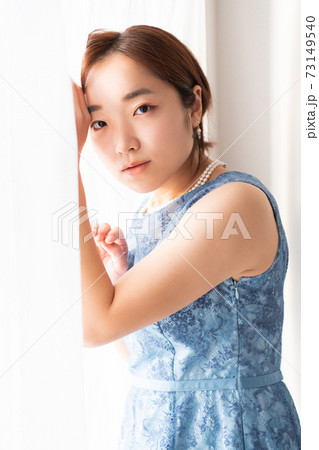 窓の前に立つドレスを着た女性 窓の前に立つドレスを着た女性 73149540