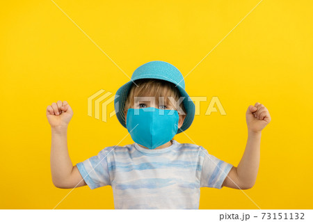 Portrait of kid wearing protective mask against yellow background 73151132