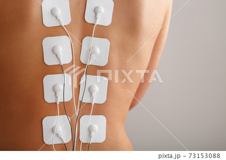 Muscle stimulator with electrodes, bacBack and shoulder massage with a muscle stimulator with attached electrodes along the spine. Muscle stimulator with electrodes, bacBack and shoulder massage with a muscle stimulator with attached electrodes along the spine. 73153088
