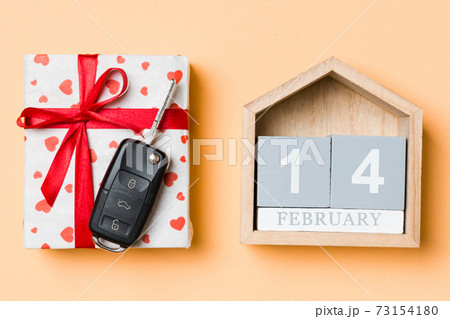 Top view of car key on a gift box with red hearts and festive calendar on colorful background. The fourteenth of february. Present for Valentine's Day concept Top view of car key on a gift box with red hearts and festive calendar on colorful background. The fourteenth of february. Present for Valentine's Day concept 73154180