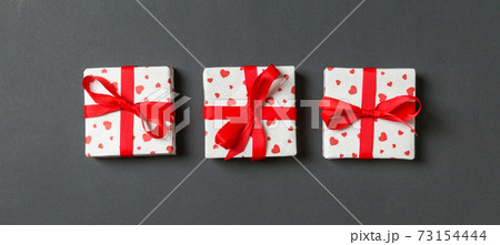 Holiday composition of gift boxes with red hearts on colorful background with empty space for your design. Top view of Valentine's Day concept Holiday composition of gift boxes with red hearts on colorful background with empty space for your design. Top view of Valentine's Day concept 73154444