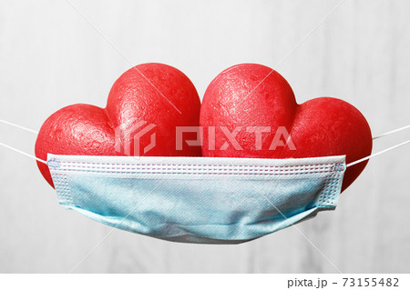 Two red hearts in a face mask hammock 73155482