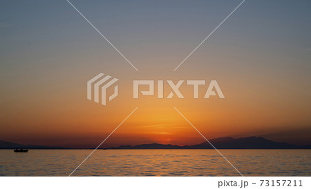 Sunset on the Aegean sea coast in Greece 73157211