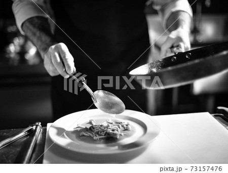 Chef cooking in a kitchen, chef at work, Black and White. Chef cooking in a kitchen, chef at work, Black and White. 73157476