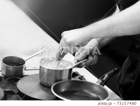 Chef cooking in a kitchen, chef at work, Black and White. 73157480