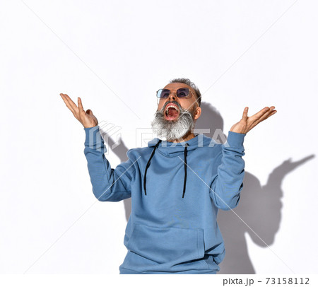 Bearded man in sunglasses, sweatshirt screaming Bearded man in sunglasses, sweatshirt screaming 73158112