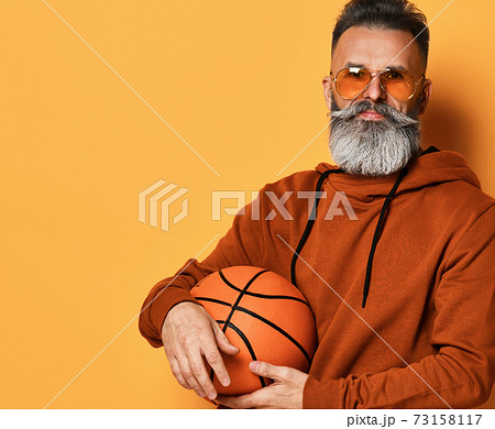 Serious bearded man in sunglasses, hoodie holding Serious bearded man in sunglasses, hoodie holding 73158117