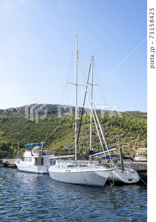 Moored boats near a village in Greece Moored boats near a village in Greece 73158425