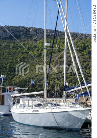 Moored boat near a village in Greece Moored boat near a village in Greece 73158432