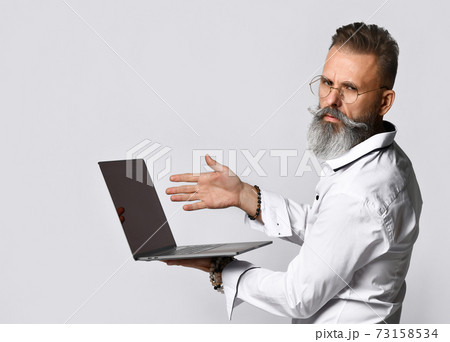 Stylish bearded hipster man in eyewear pointing to Stylish bearded hipster man in eyewear pointing to 73158534