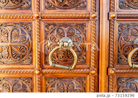 Wooden door with door knob made of bronze 73159296