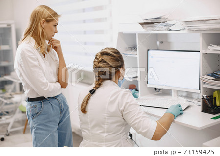 Doctor checks coronavirus test with patient Doctor checks coronavirus test with patient 73159425