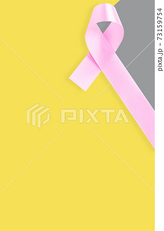Pink ribbon on gray yellow background. Cancer concept 73159754