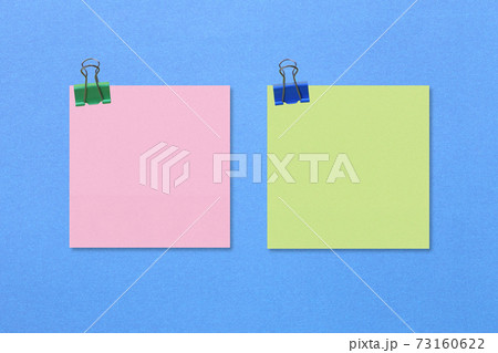 Colorful square note paper on blue paper background. Colorful square note paper on blue paper background. 73160622